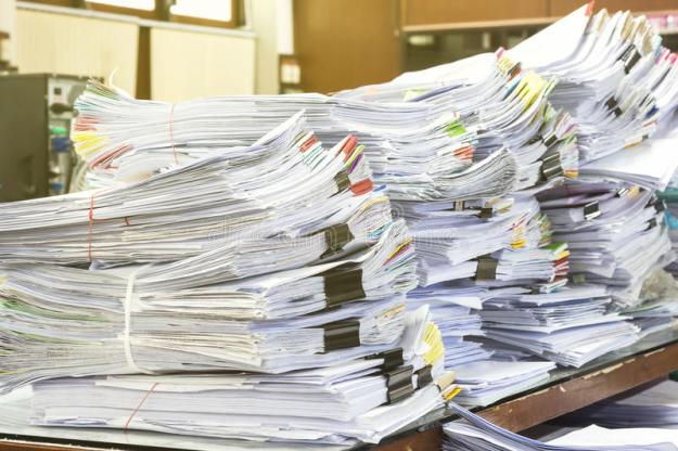 pile-documents-desk-stack-up-high-waiting-to-be-managed-76846884